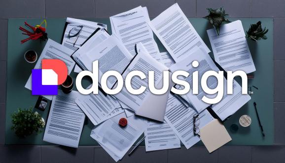 AI-generated image of a pile of contracts, agreements and documents on a desk surface with the Docusign logo overlayed on top.
